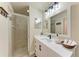 Modern bathroom with a glass-enclosed shower and sleek white vanity, blending style and functionality at 7911 Grand Estuary Trl # 102, Bradenton, FL 34212