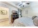 Cozy bedroom featuring a comfortable bed, ceiling fan, and ample natural light; view into bedroom at 7911 Grand Estuary Trl # 102, Bradenton, FL 34212