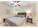Bedroom with a wicker headboard, a ceiling fan, and neutral-toned walls creating a relaxing atmosphere at 7911 Grand Estuary Trl # 102, Bradenton, FL 34212