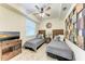 Inviting bedroom featuring twin beds, unique wall decor, and a ceiling fan for added comfort at 7911 Grand Estuary Trl # 102, Bradenton, FL 34212