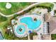 Aerial view of a beautiful community pool offering residents many comfortable chairs for relaxation and enjoyment at 7911 Grand Estuary Trl # 102, Bradenton, FL 34212