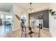 Elegant dining room showcasing a glass-top table, stylish chairs, and contemporary decor with a view of the kitchen at 7911 Grand Estuary Trl # 102, Bradenton, FL 34212
