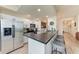 Modern kitchen with stainless steel appliances, breakfast bar seating, and an open layout to the living area at 7911 Grand Estuary Trl # 102, Bradenton, FL 34212