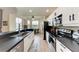 Modern kitchen featuring stainless steel appliances, sleek countertops, and views of the water at 7911 Grand Estuary Trl # 102, Bradenton, FL 34212