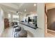 Modern kitchen with breakfast bar, stylish stools, sleek countertops, and stainless steel appliances offering lovely natural light at 7911 Grand Estuary Trl # 102, Bradenton, FL 34212