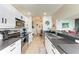Modern kitchen featuring white cabinets, stainless steel appliances, and a sleek dark countertop at 7911 Grand Estuary Trl # 102, Bradenton, FL 34212