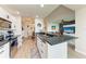 Open-concept kitchen with a breakfast bar, stainless steel appliances, and stylish lighting fixtures at 7911 Grand Estuary Trl # 102, Bradenton, FL 34212