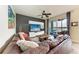 Comfortable living room with a large sectional couch and a view of the screened lanai at 7911 Grand Estuary Trl # 102, Bradenton, FL 34212