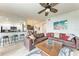 Spacious living room with a plush brown leather couch and a large painting adding a pop of color at 7911 Grand Estuary Trl # 102, Bradenton, FL 34212