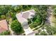 Aerial view of house showing the roof, landscaping, and long driveway at 8047 Desoto Woods Dr, Sarasota, FL 34243