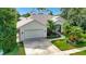 Aerial view of a well-maintained home with lush landscaping and an attached garage at 8047 Desoto Woods Dr, Sarasota, FL 34243