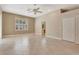 Spacious bedroom with tile flooring, ceiling fan, large window, and a double-door closet at 8047 Desoto Woods Dr, Sarasota, FL 34243