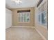 Bedroom featuring tile floors, neutral walls, a ceiling fan, and plantation shutters at 8047 Desoto Woods Dr, Sarasota, FL 34243
