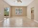Spacious bedroom with tile flooring, ceiling fan, slider doors to patio, and window with plantation shutters at 8047 Desoto Woods Dr, Sarasota, FL 34243