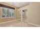 Bedroom featuring tile floors, closet with mirrored doors and a window with blinds at 8047 Desoto Woods Dr, Sarasota, FL 34243