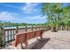 Scenic wooden dock with benches overlooking a tranquil lake and lush greenery at 8047 Desoto Woods Dr, Sarasota, FL 34243