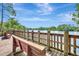 Scenic wooden dock with benches overlooking a tranquil lake and lush greenery at 8047 Desoto Woods Dr, Sarasota, FL 34243