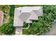 Aerial view of a well-maintained home featuring a neutral-toned roof and landscaped front yard at 8047 Desoto Woods Dr, Sarasota, FL 34243