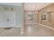 Bright foyer with neutral colors, tiled floor, and transom window over the front door at 8047 Desoto Woods Dr, Sarasota, FL 34243