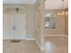 Bright foyer with neutral colors, tiled floor, and transom window over the front door at 8047 Desoto Woods Dr, Sarasota, FL 34243