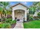 Charming home exterior with landscaped front yard and covered entrance at 8047 Desoto Woods Dr, Sarasota, FL 34243