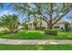Charming single-story home with mature landscaping and green lawn at 8047 Desoto Woods Dr, Sarasota, FL 34243