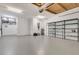 Spacious three car garage with overhead storage and painted concrete floors at 8047 Desoto Woods Dr, Sarasota, FL 34243