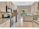 This kitchen features stainless steel appliances, granite countertops, and white cabinetry at 8047 Desoto Woods Dr, Sarasota, FL 34243