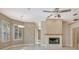 Inviting living room featuring a cozy fireplace, plantation shutters and lots of natural light at 8047 Desoto Woods Dr, Sarasota, FL 34243