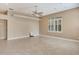 Large, open living room with neutral walls, plantation shutters, and tile flooring at 8047 Desoto Woods Dr, Sarasota, FL 34243