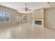 Open-concept living room with tile floors, fireplace, and bright shuttered windows at 8047 Desoto Woods Dr, Sarasota, FL 34243
