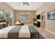 Staged main bedroom featuring tile flooring, ceiling fan, and slider doors to patio with ensuite bathroom at 8047 Desoto Woods Dr, Sarasota, FL 34243