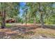 Community playground with swings and spring riders nestled among mature trees and lush landscaping at 8047 Desoto Woods Dr, Sarasota, FL 34243
