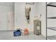 Utility room featuring a water heater, central vac, and shelving at 8047 Desoto Woods Dr, Sarasota, FL 34243