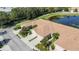 Aerial view displaying townhomes with tile roofs, driveways, and landscaped front yards along a picturesque pond at 8224 Simpson Falls Ct # 8224, Sarasota, FL 34243