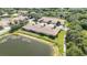 Aerial view displaying homes with tile roofs, manicured landscaping, and views of a peaceful pond at 8224 Simpson Falls Ct # 8224, Sarasota, FL 34243