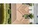Aerial view showing townhomes with tile roofs and manicured yards, offering serene pond views at 8224 Simpson Falls Ct # 8224, Sarasota, FL 34243