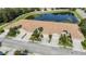 Beautiful aerial view of townhomes showcasing tile roofs and well-manicured landscaping near a scenic pond at 8224 Simpson Falls Ct # 8224, Sarasota, FL 34243