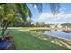 Lush backyard with pond and tropical landscaping creates a private oasis at 8224 Simpson Falls Ct # 8224, Sarasota, FL 34243