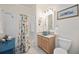 Well-lit bathroom featuring colorful shower curtain and unique sink basin at 8224 Simpson Falls Ct # 8224, Sarasota, FL 34243