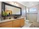 Modern bathroom featuring a granite countertop, vessel sink, framed mirror, and glass-enclosed shower at 8224 Simpson Falls Ct # 8224, Sarasota, FL 34243