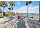 Relaxing lakeside beach featuring Adirondack chairs, offering a serene spot with scenic water views at 8224 Simpson Falls Ct # 8224, Sarasota, FL 34243