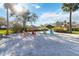 Sandy beach with Adirondack chairs offers a relaxing waterfront space near community amenities at 8224 Simpson Falls Ct # 8224, Sarasota, FL 34243