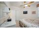 Bright bedroom features ceiling fan, television, and ample closet space at 8224 Simpson Falls Ct # 8224, Sarasota, FL 34243