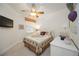 Charming bedroom with carpet, ceiling fan, TV, white dresser, and a comfy bed, creating a relaxing retreat at 8224 Simpson Falls Ct # 8224, Sarasota, FL 34243