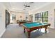 Billiard room with two pool tables, natural lighting, and a sitting area at 8224 Simpson Falls Ct # 8224, Sarasota, FL 34243