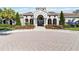 A beautiful single-story clubhouse with a well-manicured lawn, mature trees and inviting entrance at 8224 Simpson Falls Ct # 8224, Sarasota, FL 34243