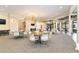 Spacious room with tables, chairs, and hanging chandeliers in the Lakeridge Falls Clubhouse at 8224 Simpson Falls Ct # 8224, Sarasota, FL 34243