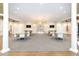 Spacious room with tables, chairs, and hanging chandeliers in the Lakeridge Falls Clubhouse at 8224 Simpson Falls Ct # 8224, Sarasota, FL 34243
