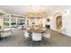 Spacious room with tables, chairs, and hanging chandeliers in the Lakeridge Falls Clubhouse at 8224 Simpson Falls Ct # 8224, Sarasota, FL 34243